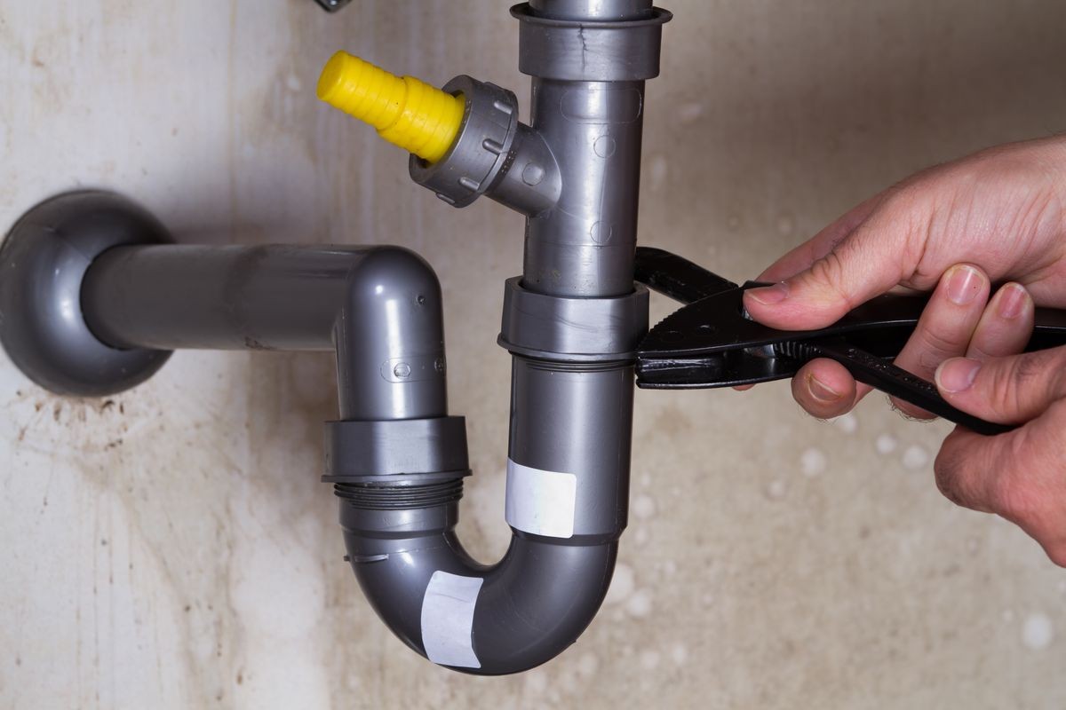 plumber at work to fix a sink plumber at work to fix a sink